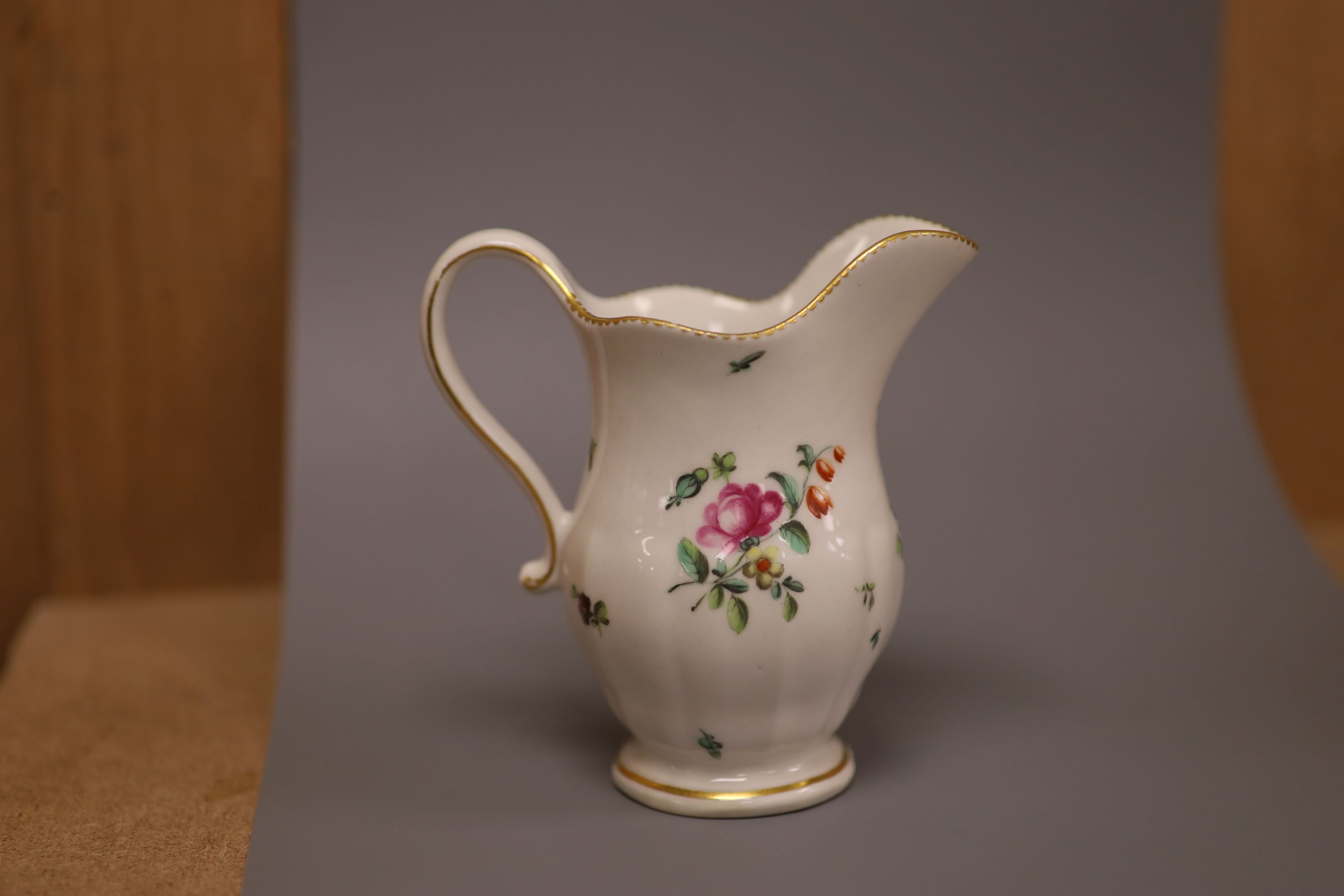 A Derby moulded jug, painted with flowers in manner of Edward Withers, c.1772, height 12cm